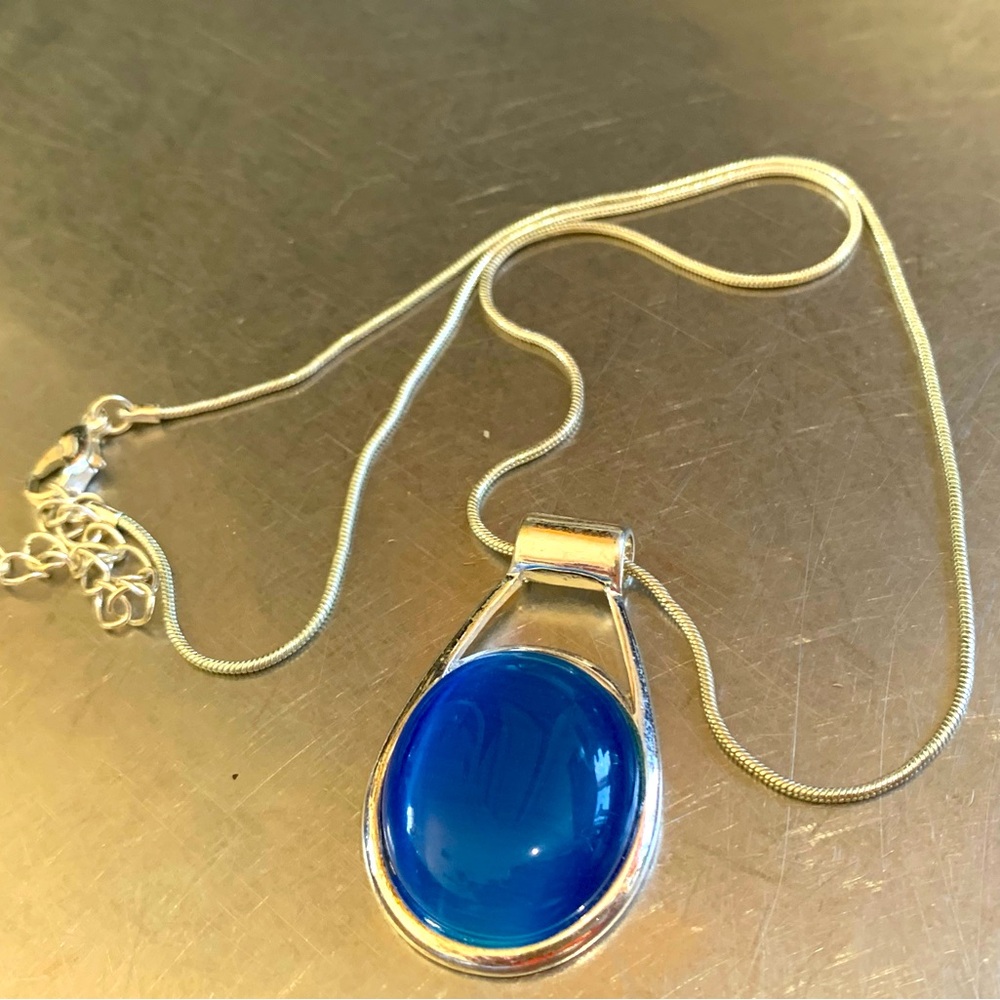Fun blue glass pendant with silver chain.
